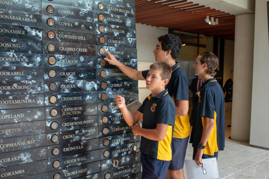 Stage 5 students from regional NSW viewing Fiona Hall artwork in the Hall of Service